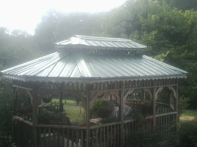 Two tier green metal roof on a garden gazebo in South Orange