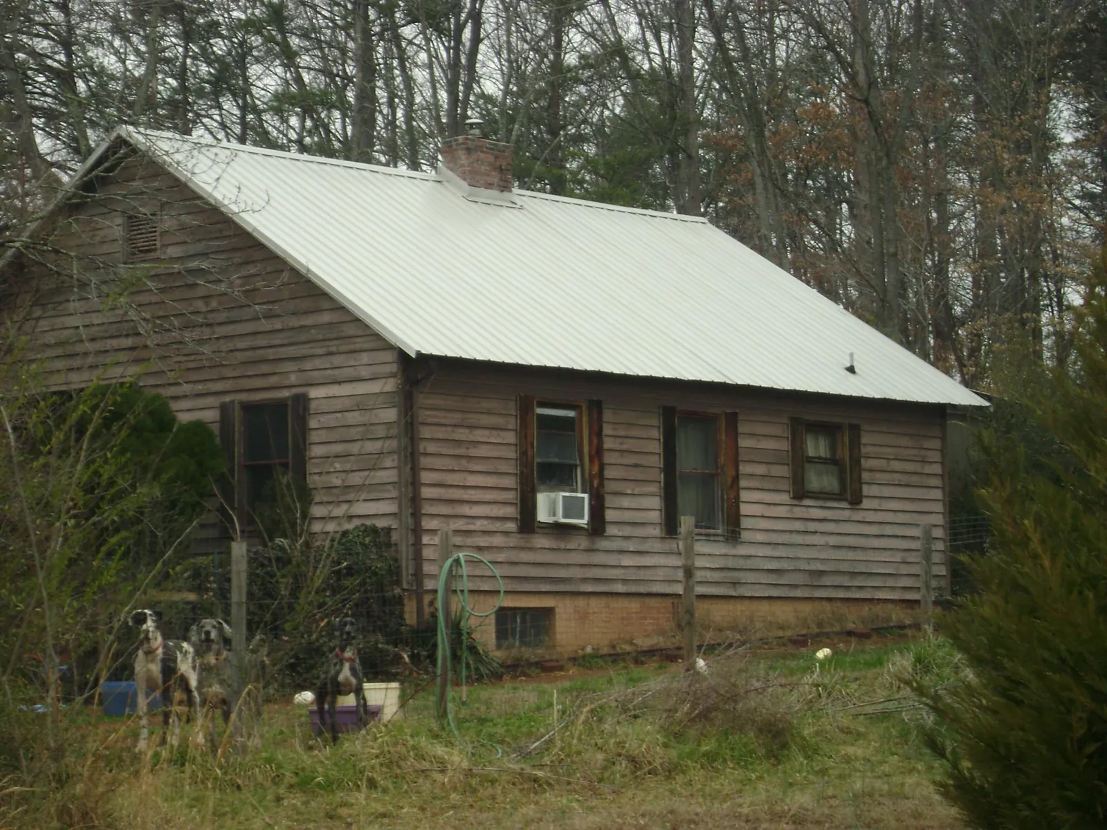 White metal roof on an old wood sided farmhouse, from a Metal Roof Installation job in South Orange